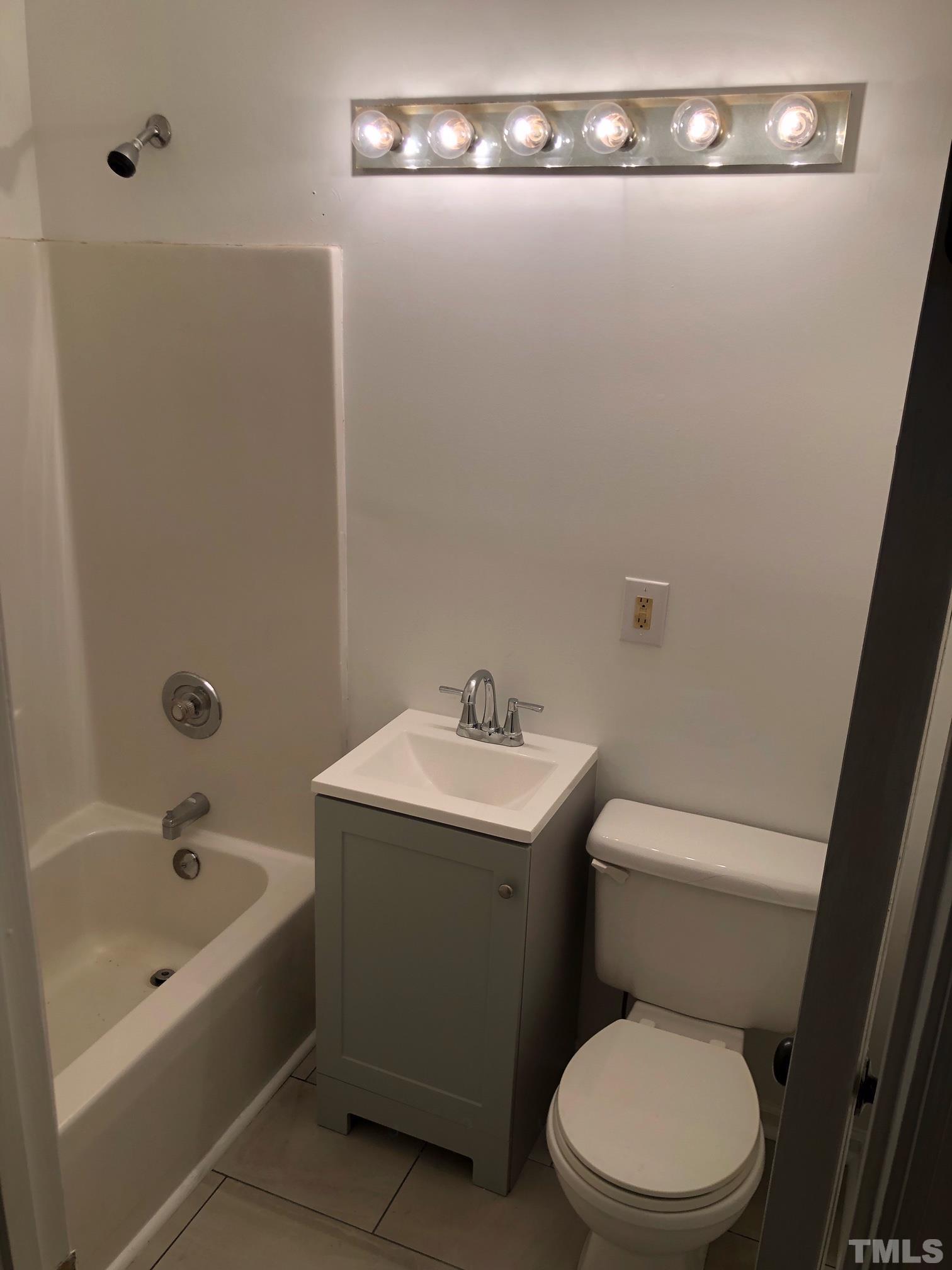 2103 Collier Road Durham, NC 27707 - Photo 19 of 23 a white toilet sitting next to a bathroom sink