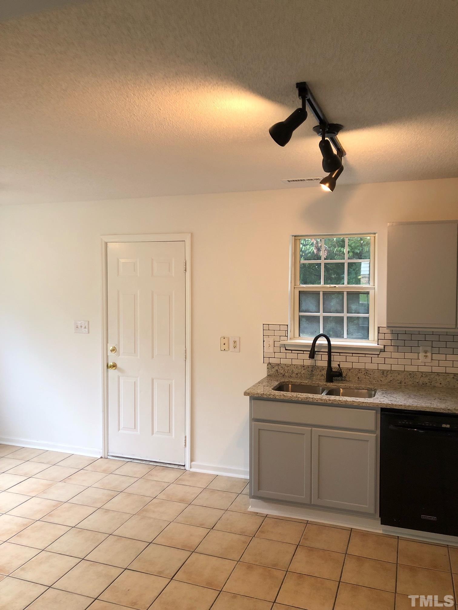 2103 Collier Road Durham, NC 27707 - Photo 9 of 23 a kitchen with a sink and cabinets