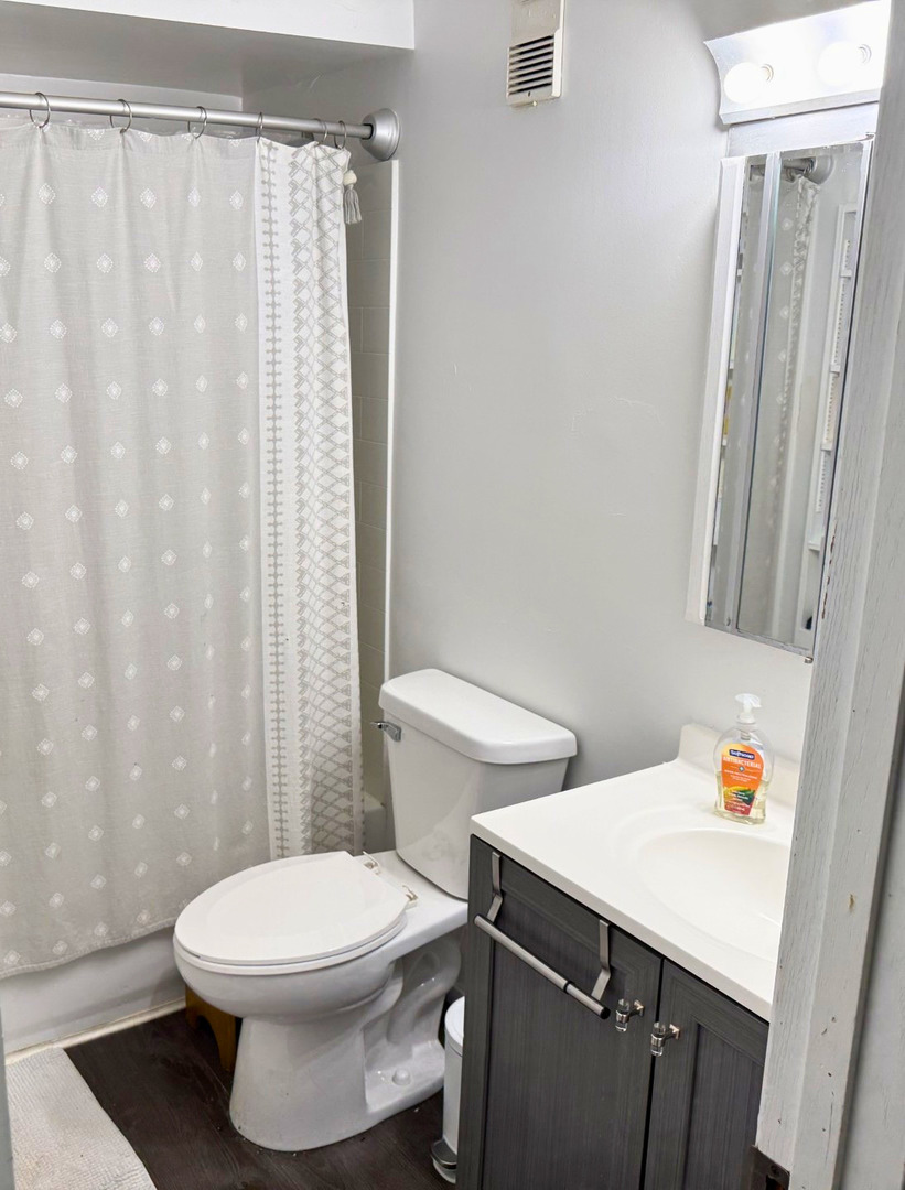 942 North Rohlwing Road, Unit GF Addison, IL 60101 - Photo 7 of 8 a white toilet sitting next to a bathroom sink