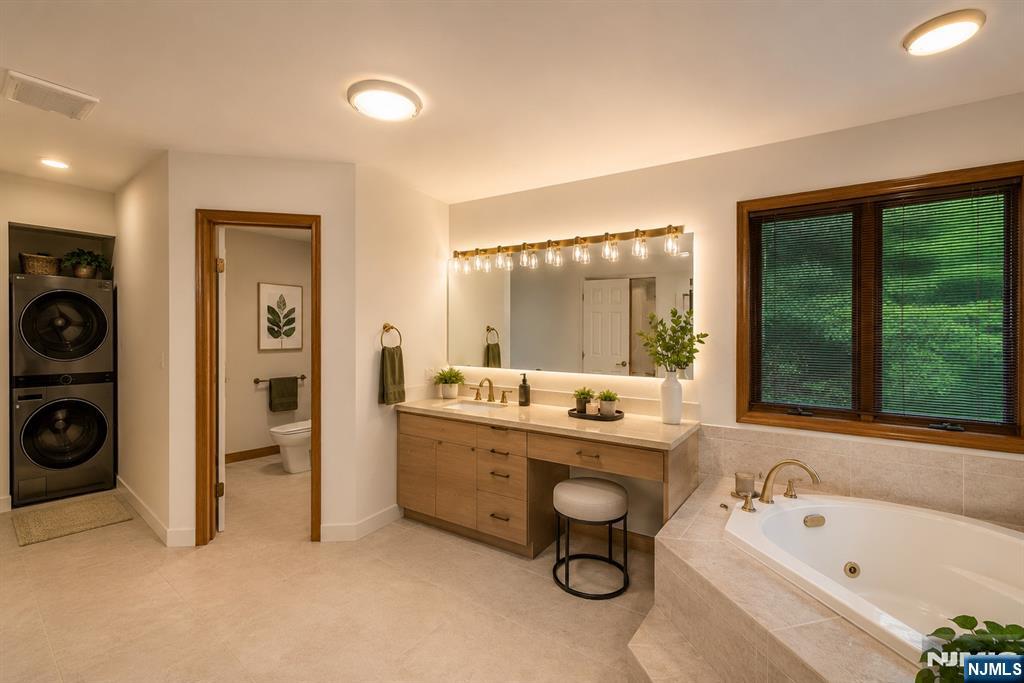 12 Abbott Road Wayne, NJ 07470 - Photo 27 of 49 a bathroom with a tub sink and mirror