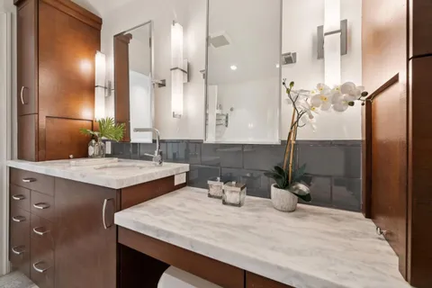 a bathroom with a bathtub a shower a sink and a window