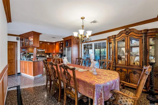 a dining room with a table chairs and a chandelier
