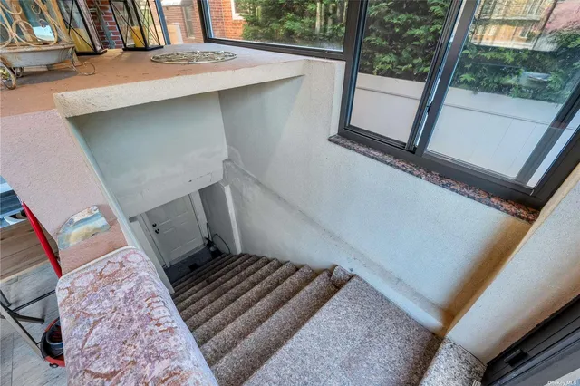 a view of hallway with furniture and wooden floor