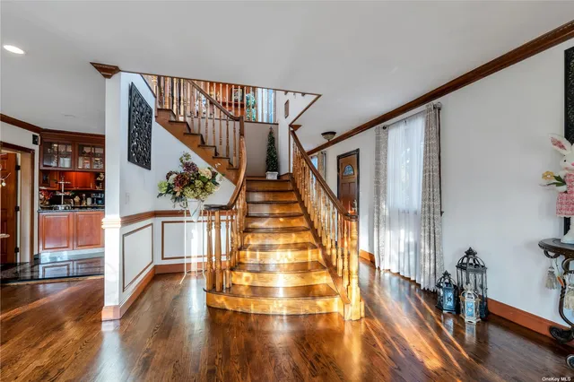 a view of entryway and hall with wooden floor