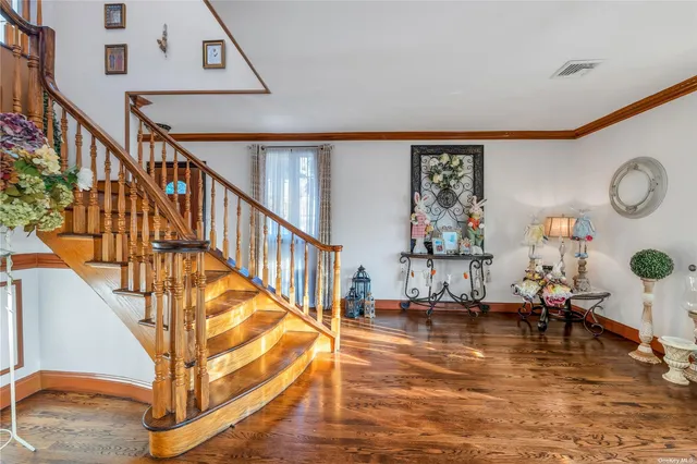 a view of entryway livingroom and hall with wooden floor