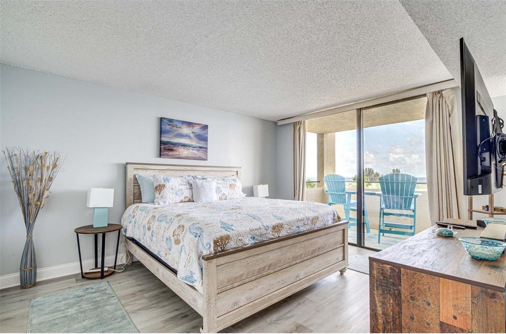 5915 Sea Ranch Drive, Unit 310 Hudson, FL 34667 - Photo 11 of 25 a bedroom with a large bed and a large window