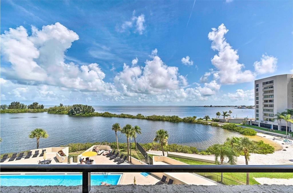5915 Sea Ranch Drive, Unit 310 Hudson, FL 34667 - Photo 17 of 25 a view of a lake with a table and chairs