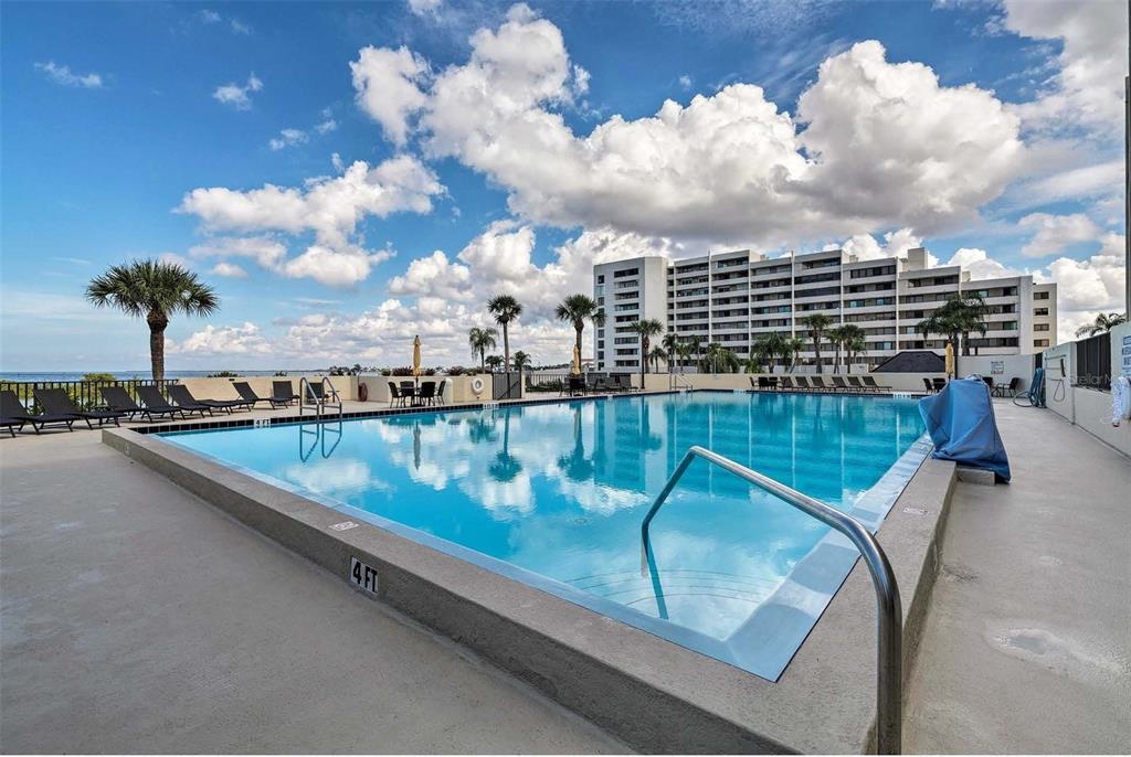 5915 Sea Ranch Drive, Unit 310 Hudson, FL 34667 - Photo 19 of 25 a view of swimming pool with outdoor seating and city view