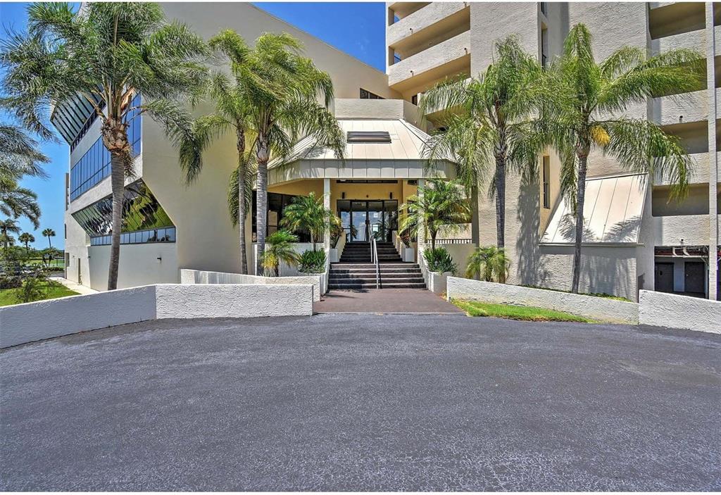 5915 Sea Ranch Drive, Unit 310 Hudson, FL 34667 - Photo 2 of 25 front view of a house with a yard
