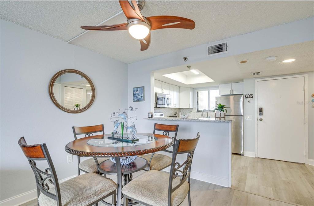 5915 Sea Ranch Drive, Unit 310 Hudson, FL 34667 - Photo 6 of 25 a dining room with furniture and a chandelier