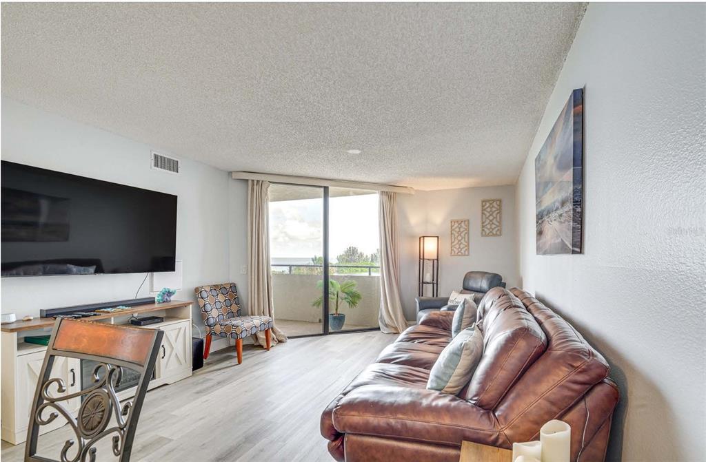 5915 Sea Ranch Drive, Unit 310 Hudson, FL 34667 - Photo 9 of 25 a living room with furniture and a flat screen tv