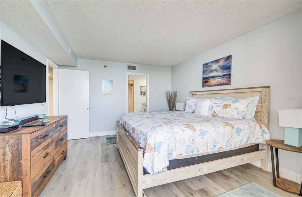 5915 Sea Ranch Drive, Unit 310 Hudson, FL 34667 - Photo 10 of 25 a bedroom with a bed and a flat screen tv