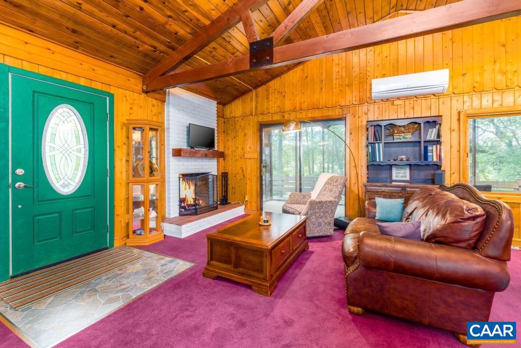 237 Westwood Road Stanardsville, VA 22973 - Photo 12 of 47 a living room with furniture a fireplace and a large window