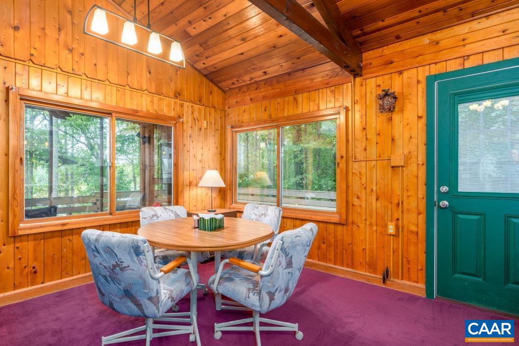 237 Westwood Road Stanardsville, VA 22973 - Photo 13 of 47 a dining room with furniture a chandelier and wooden floor