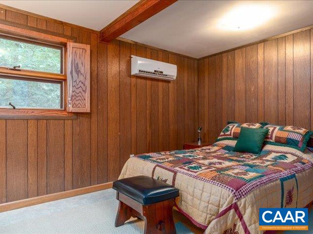237 Westwood Road Stanardsville, VA 22973 - Photo 28 of 47 a bed sitting in a bedroom next to a window