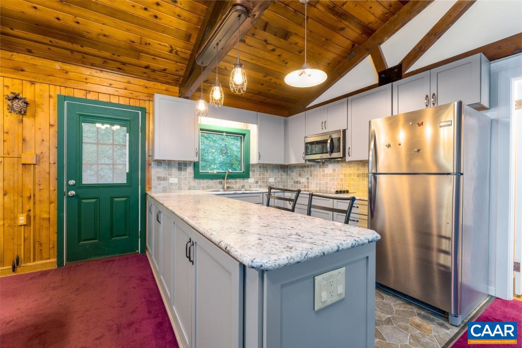 237 Westwood Road Stanardsville, VA 22973 - Photo 9 of 47 a kitchen with granite countertop a refrigerator a sink and dishwasher