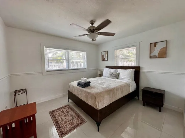 a bedroom with a bed dresser and a window