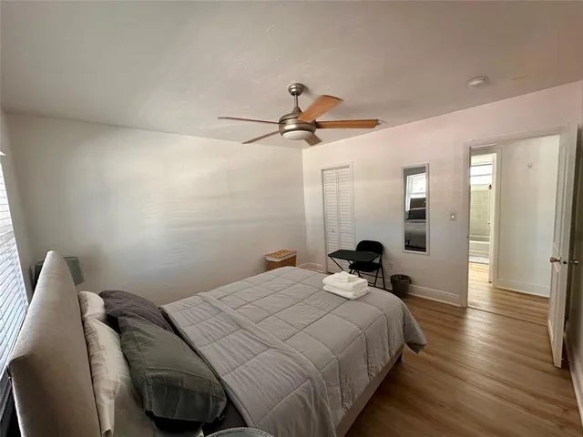 a bedroom with a bed and a chandelier