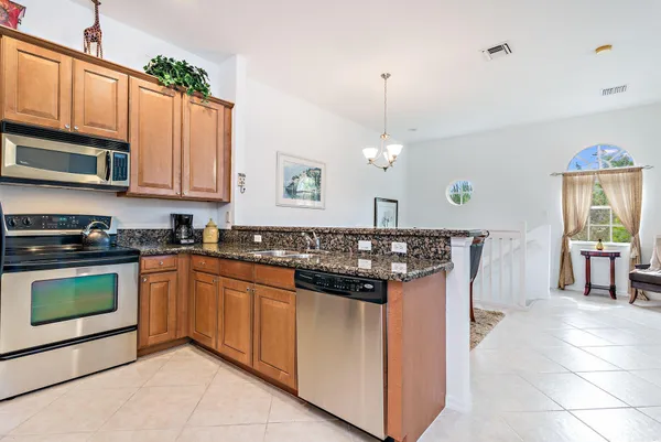 a kitchen with stainless steel appliances granite countertop a stove and a sink