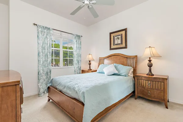 a bedroom with a bed dresser and a window