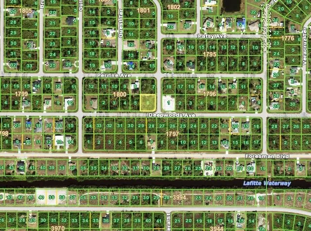 a view of a building with a yard and plants