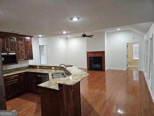 a kitchen with sink cabinets and wooden floor