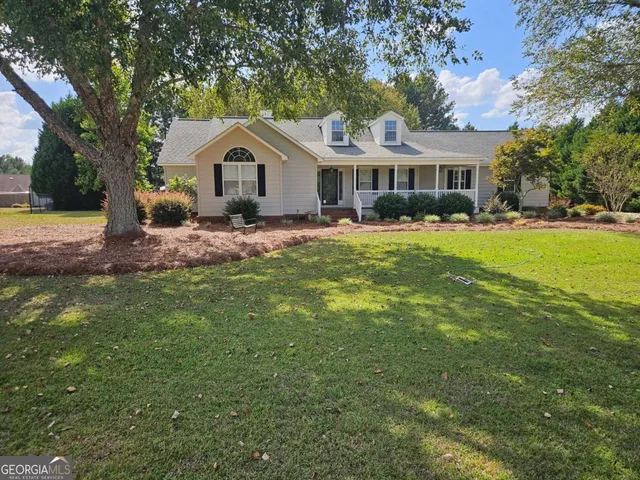 a front view of a house with yard porch and green space