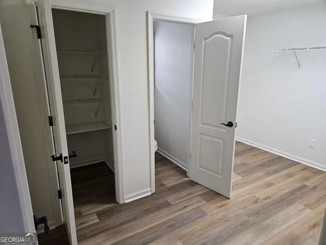 a view of a room with wooden floor