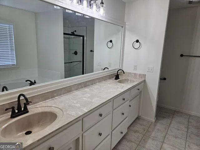 a bathroom with a shower and a sink