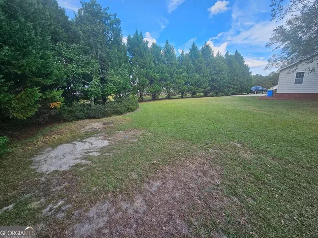 a view of a yard with a tree