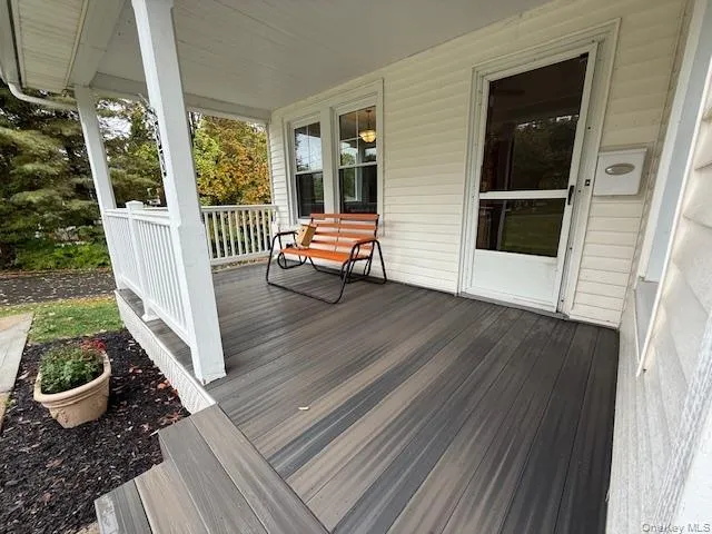 a view of outdoor space with porch and wooden floor