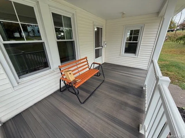 a bench sitting in front of a house