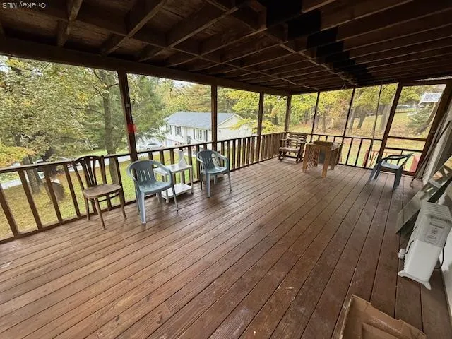 a view of porch with green trees in front