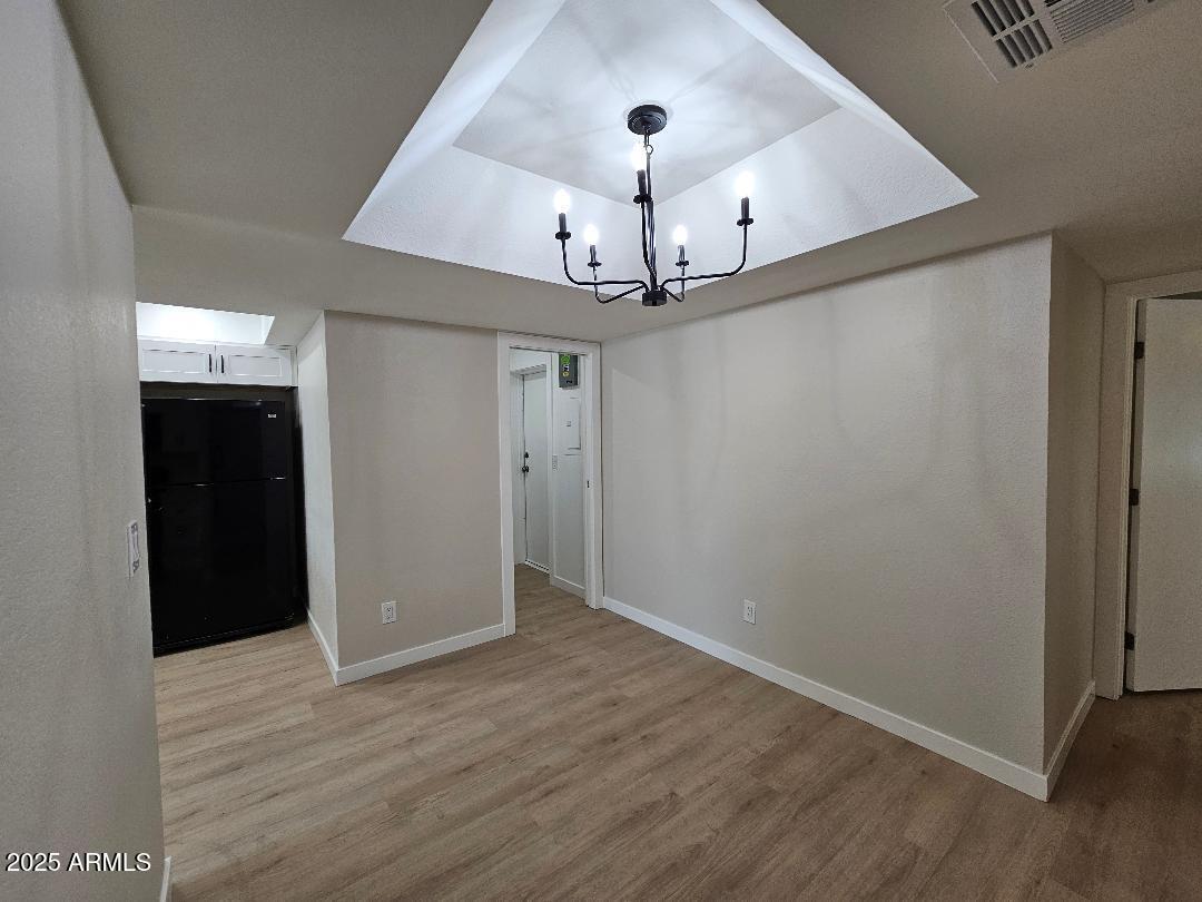 2020 West Union Hills Drive, Unit 116 Phoenix, AZ 85027 - Photo 10 of 28 an empty room with wooden floor chandelier fan and entryway