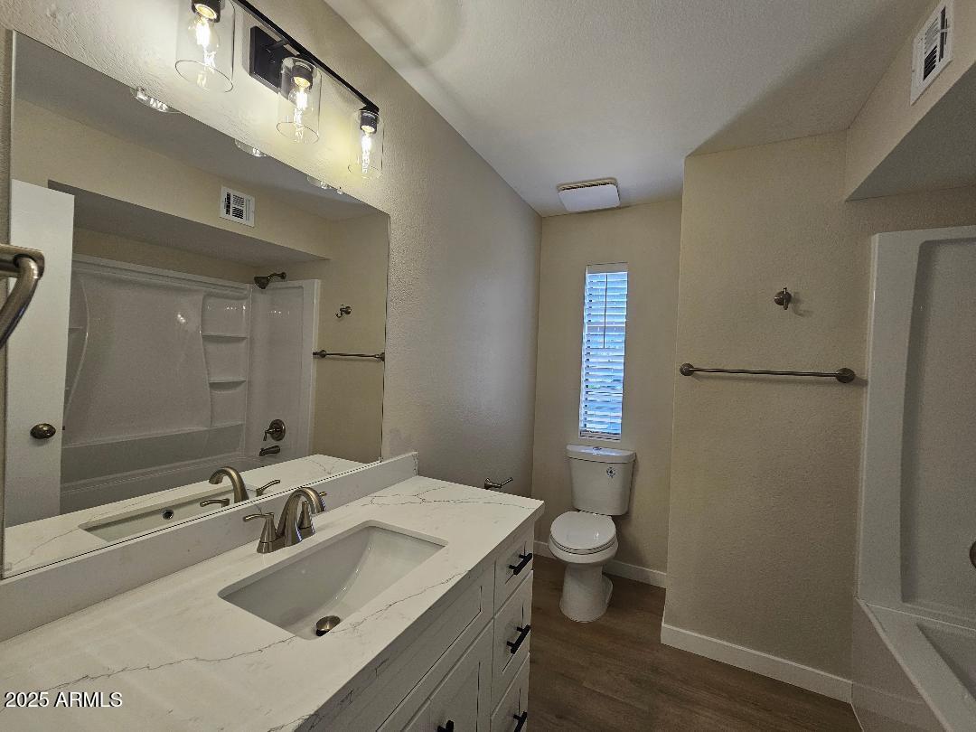 2020 West Union Hills Drive, Unit 116 Phoenix, AZ 85027 - Photo 18 of 28 a bathroom with a sink and mirror with toilet