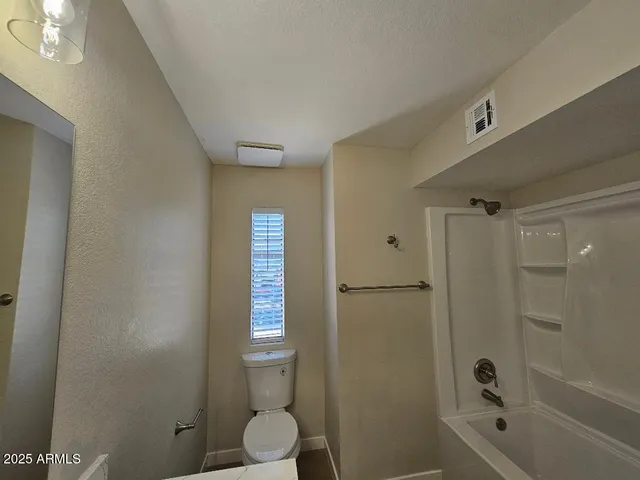 a bathroom with a sink and mirror with toilet