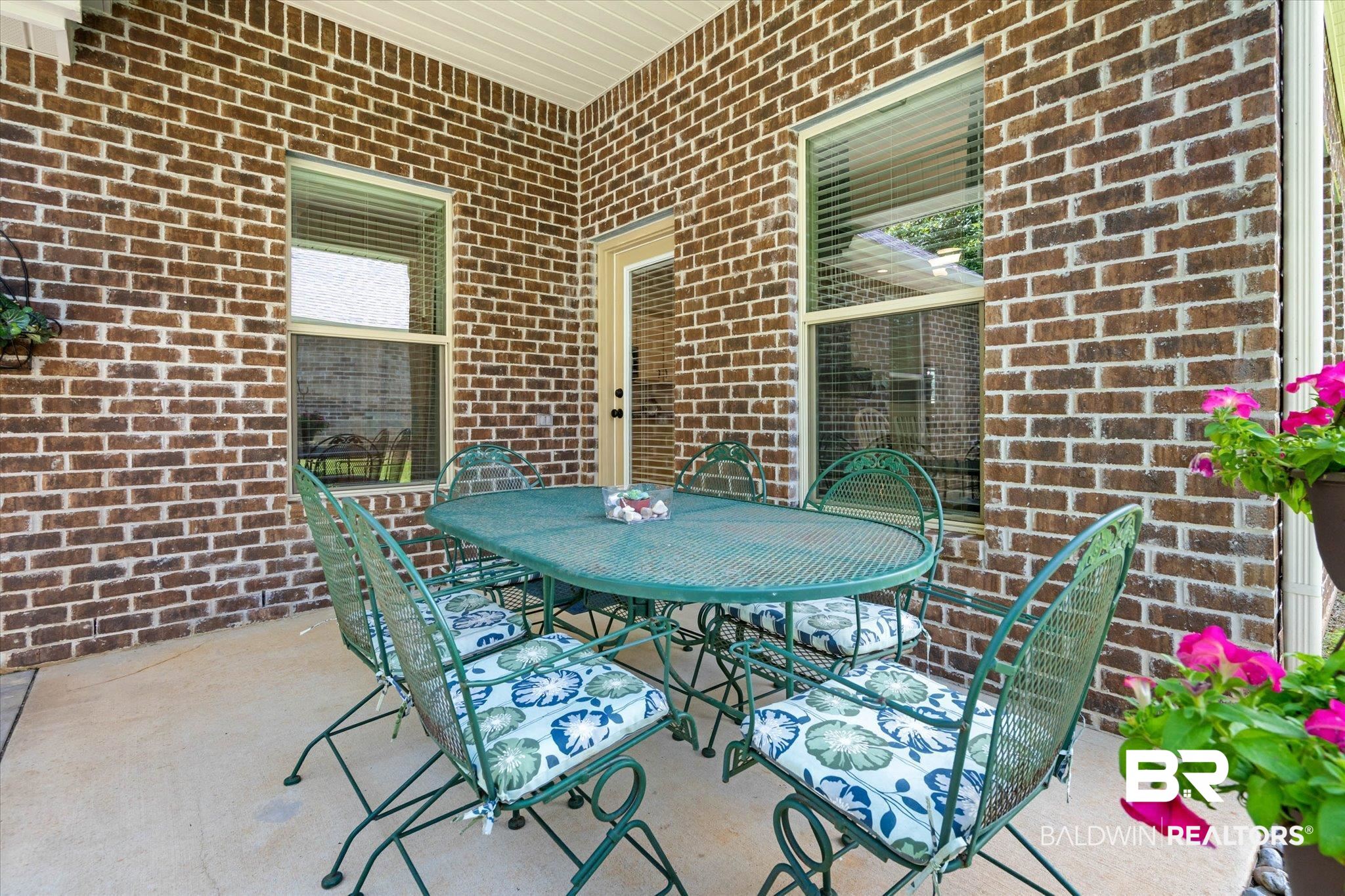 1270 Surrey Loop Foley, AL 36535 - Photo 22 of 27 Covered patio with brick siding and a smooth concrete surface