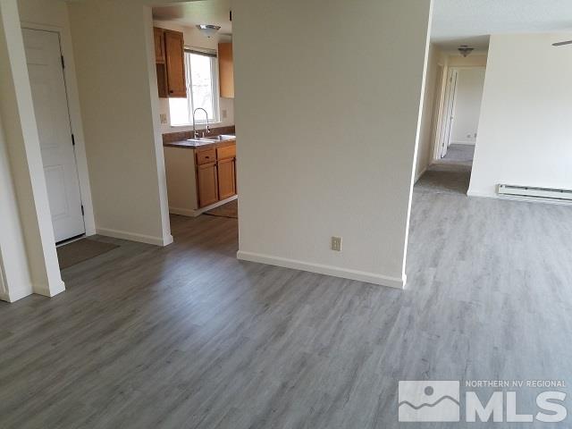 3420 Brant Street Reno, NV 89508 - Photo 7 of 20 an empty room with wooden floor and entrance
