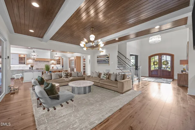 a very nice looking living room with furniture and a chandelier