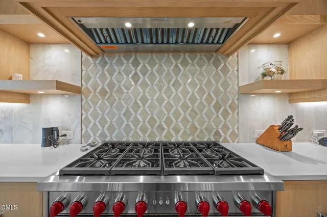 a stove sitting inside of a kitchen