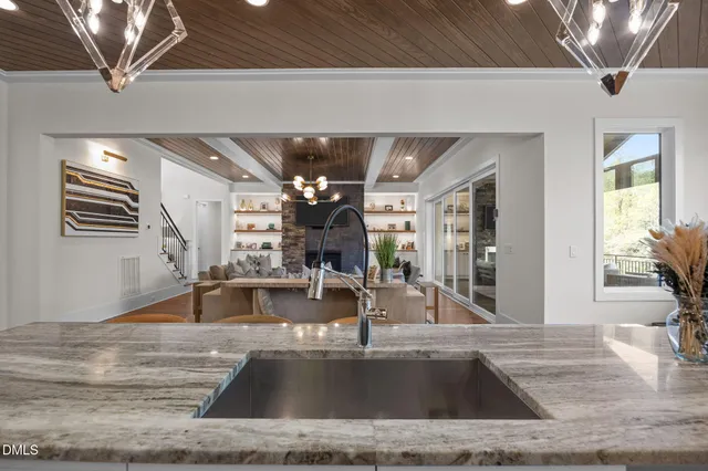 a view of kitchen with stainless steel appliances granite countertop sink and cabinets