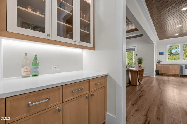 a hallway with sink and wooden floor