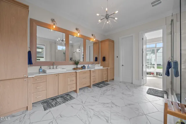 a bathroom with a sink mirror and a shower