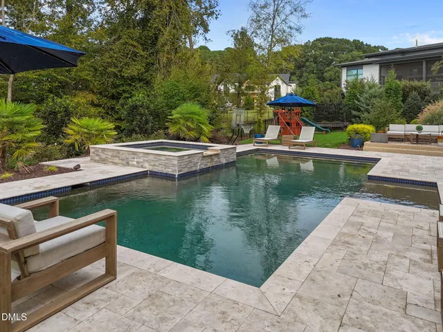 a front view of a house with swimming pool and porch