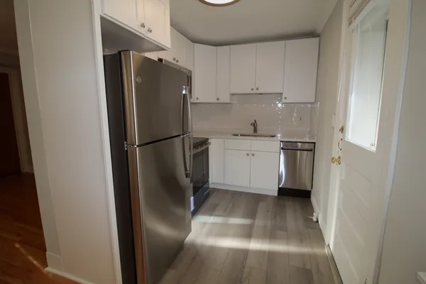 a kitchen with stainless steel appliances a refrigerator and a sink