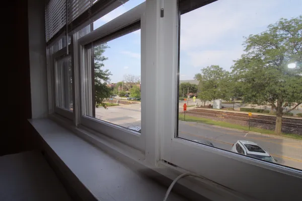 a view of a balcony with lake view and a floor to ceiling window