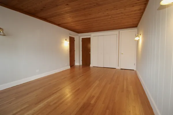 a view of hallway with wooden floor