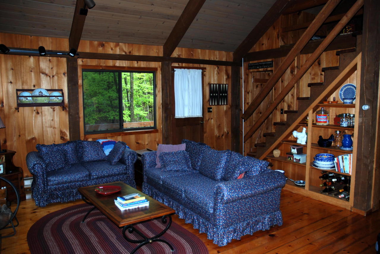221 Judd Road Otis, MA 01253 - Photo 3 of 23 a living room with furniture a bookshelf and a window