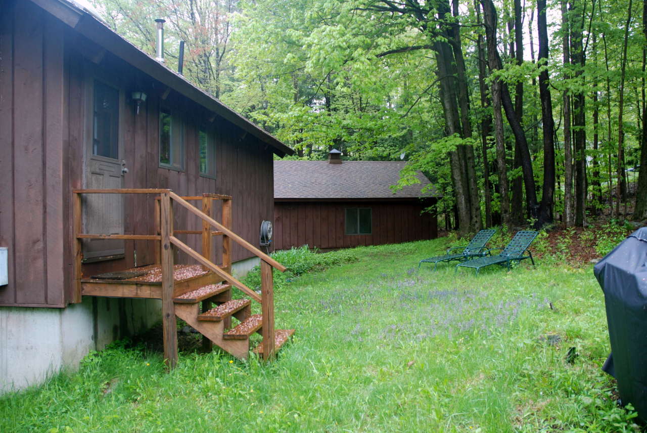 221 Judd Road Otis, MA 01253 - Photo 22 of 23 a view of a backyard with plants and a slide