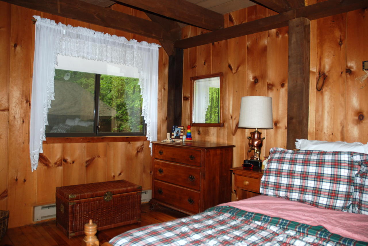 221 Judd Road Otis, MA 01253 - Photo 10 of 23 a bedroom with a bed and a dresser next to a window